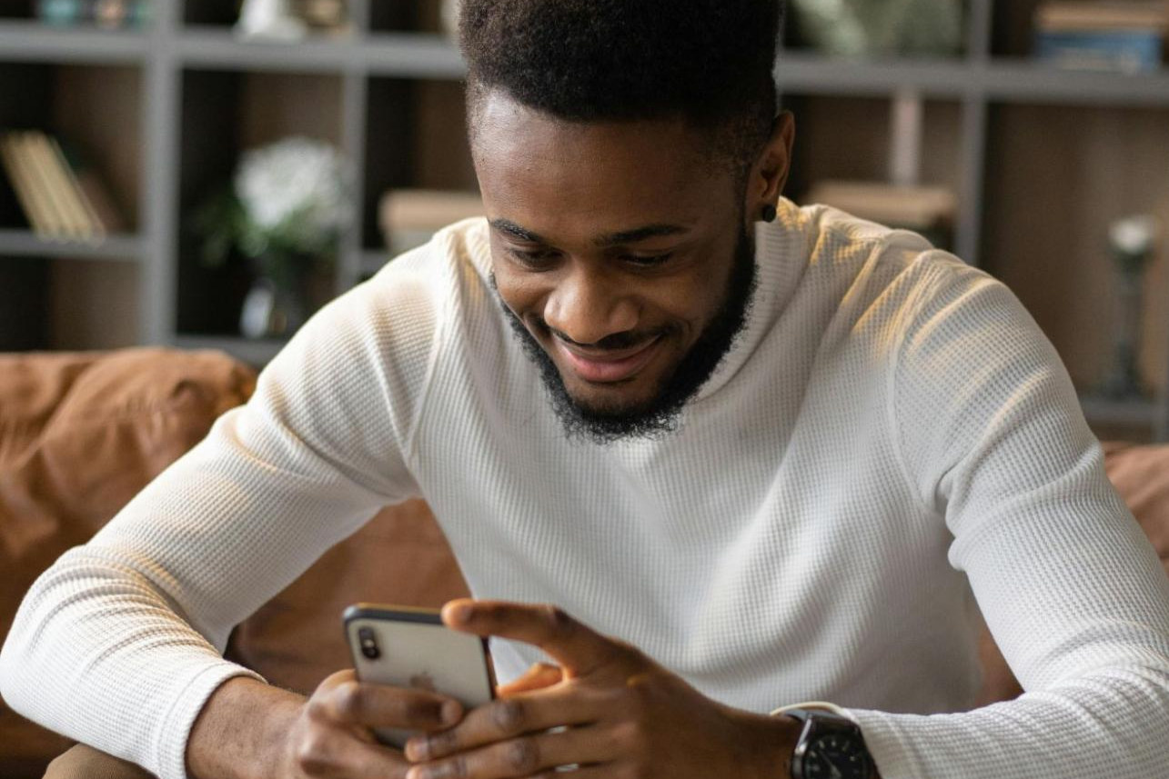 man messaging on his phone, enjoying his conversations from dating apps