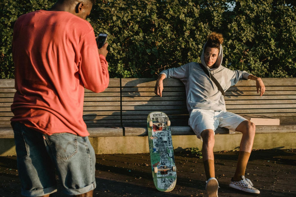 Photographer taking a full body photo of his friend for dating apps