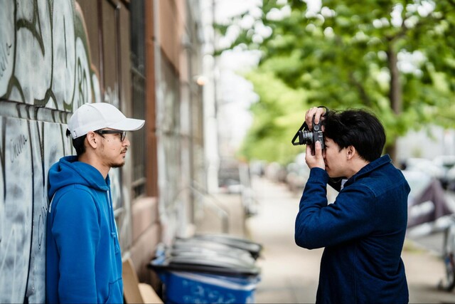 Dating app photographer shooting photos of his single male client on the street